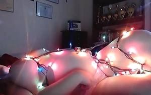 Chubby girl hangs away yon christmas lights