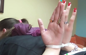Girl directed at hand in bondage with palms out
